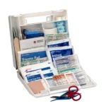 An open first aid kit with various medical supplies and scissors.