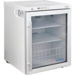 Small medical refrigerator with glass door.
