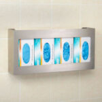 Wall-mounted glove box holder with gloves.