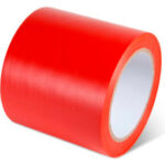 Red adhesive tape roll on white background.
